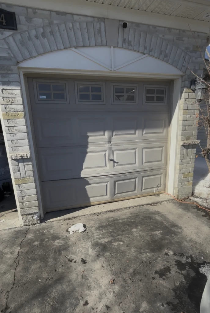 Damaged garage door before replacement